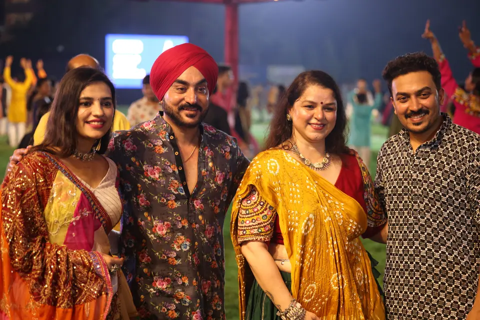 Four friends in festive clothes posing together