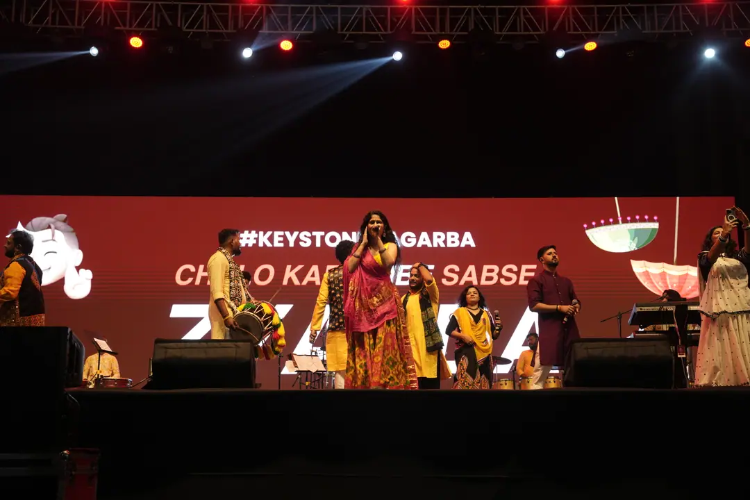 The band on stage under a #KEYSTONENAGARBA screen