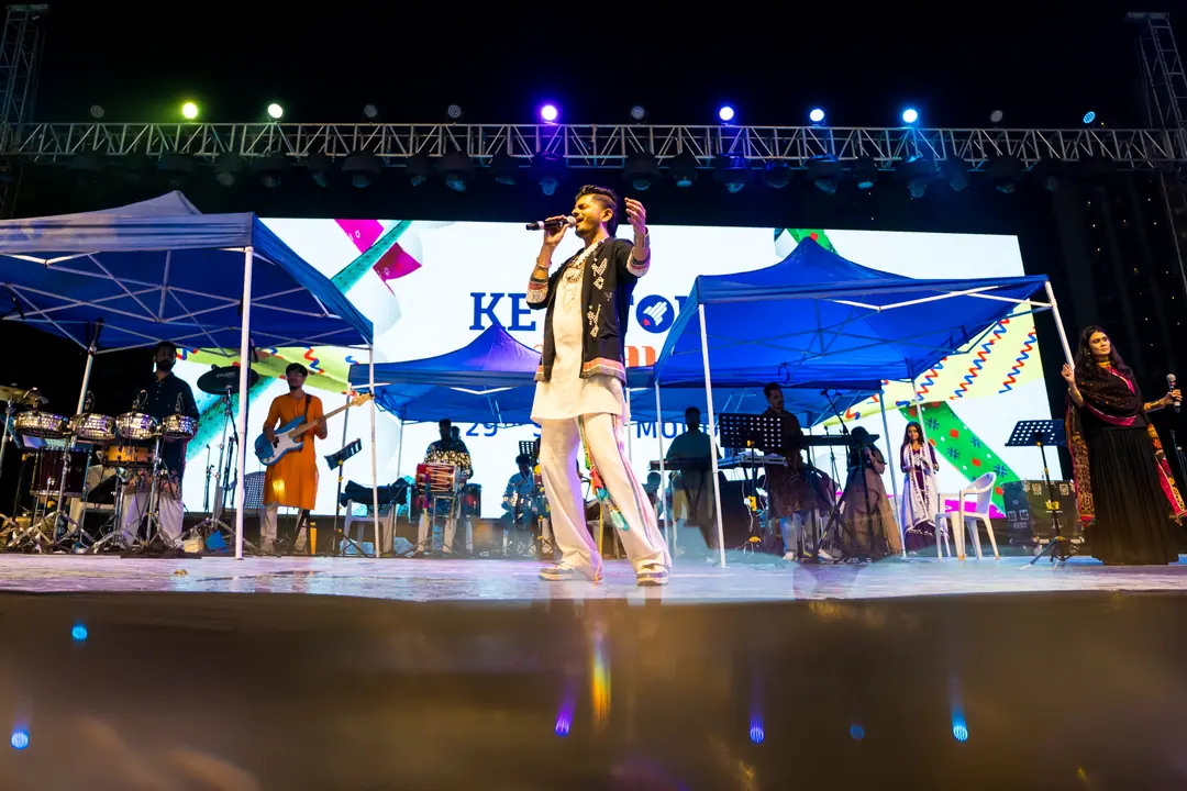 A singer on the PYC stage, the Keystone name on the LED wall behind the band